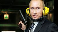Vladimir Putin at a shooting range, holding a handgun.