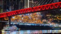 CHONGQING, CHINA - APRIL 30: Tourists visit Jiangbeizui Jiangtan Park under Qiansimen Jialing River Bridge ahead of the May Day holiday on April 30, 2025 in Chongqing, China. The five-day May Day holiday will start on May 1 this year. (Photo by Fuyu Jianglin/VCG via Getty Images)