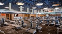 Abandoned airport waiting area with dirty seats.