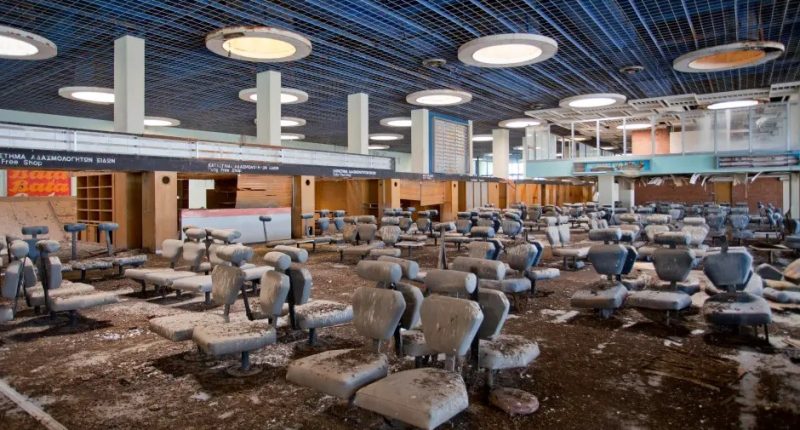 Abandoned airport waiting area with dirty seats.