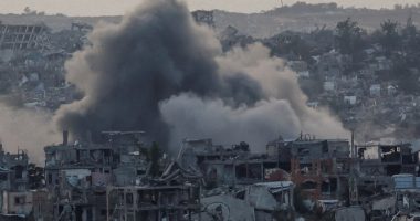Smoke rises over destroyed buildings in Gaza following an explosion.