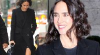 Jennifer Connelly flashes her trim pins in black wool coat and sandals