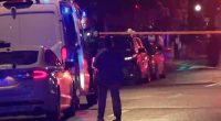 Crime scene with police and emergency vehicles.