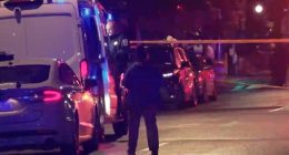 Crime scene with police and emergency vehicles.