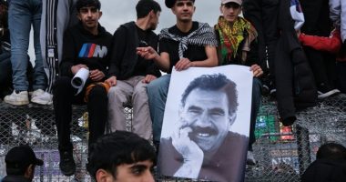 Kurdish youths with a poster of jailed PKK leader Abdullah Öcalan in Diyarbakir, south-eastern Turkey, in March