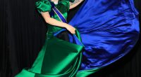 Lady Gaga in a green and blue satin gown backstage.