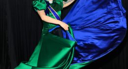 Lady Gaga in a green and blue satin gown backstage.