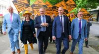 Ed Davey and other Liberal Democrat candidates and supporters walking while campaigning.