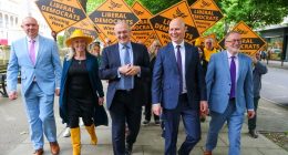 Ed Davey and other Liberal Democrat candidates and supporters walking while campaigning.
