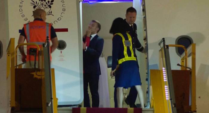Macron says he and wife were horsing around when she appears to push the French leader