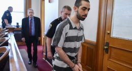 Man throws final insults as he is jailed for 25 years for stabbing famous author