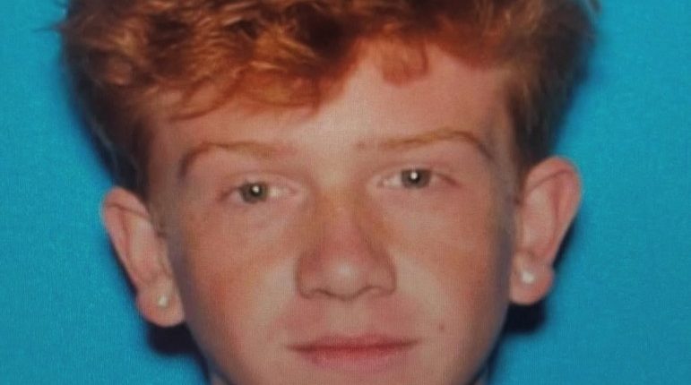 Mugshot of a young man with red hair.