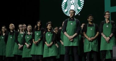 Starbucks baristas stand on stage, March 20, 2019, during an annual shareholders meeting in Seattle. (AP Photo/Ted S. Warren, file)