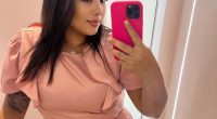 Woman taking a selfie in a pink outfit.