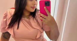 Woman taking a selfie in a pink outfit.