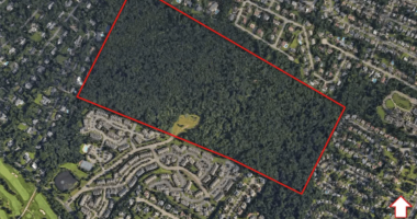 Aerial view of a 120-acre plot of land proposed for a 496-unit apartment complex.
