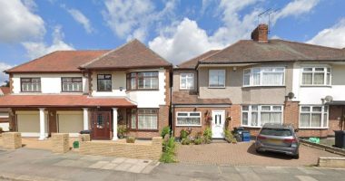 Two houses separated by a narrow gap.