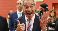 Nigel Farage giving a thumbs-up and reacting excitedly.