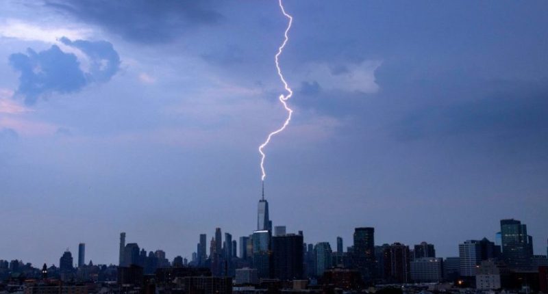 A lightning bolt strikes One World Trade Center during a thunderstorm in New York City on June 22, 2024, as seen from Jersey City, New Jersey. (Photo by Gary Hershorn/Getty Images)