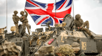 British soldiers with a Union Jack on a military vehicle.