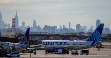 United Airlines planes at Newark International Airport with a city skyline in the background.