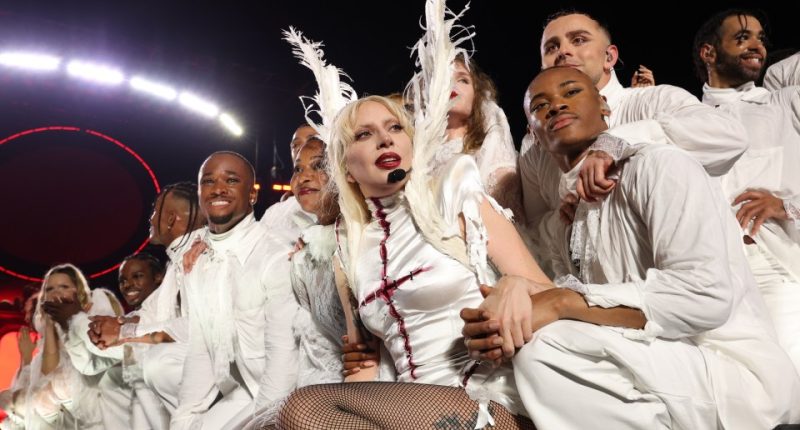 Lady Gaga performing on Copacabana Beach with backup dancers.
