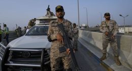 A paramilitary soldier stand alert on a road near Karachi port
