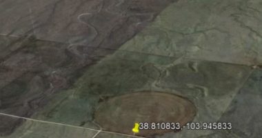 Aerial view of farmland with circular patterns.
