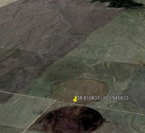 Aerial view of farmland with circular patterns.