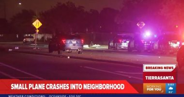 Small plane crash in a neighborhood at night.