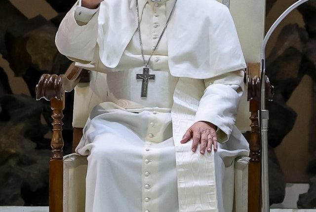 Pope Leo XIV waving to people.