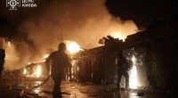 Ukrainian firefighters extinguishing a fire at a missile attack site in Kyiv.