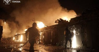 Ukrainian firefighters extinguishing a fire at a missile attack site in Kyiv.