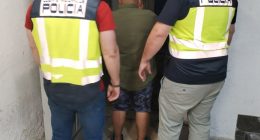 Police officers arresting a suspect.