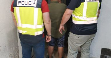 Police officers arresting a suspect.