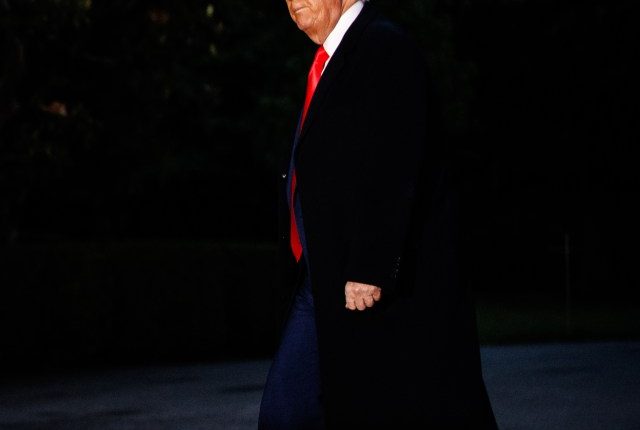 Donald Trump walking at night.