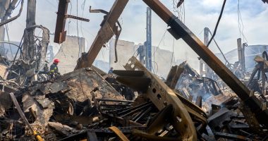 Firefighters at the site of a damaged warehouse after a drone attack.