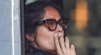 Salma Hayek puffs on a cigarette while stuck in traffic