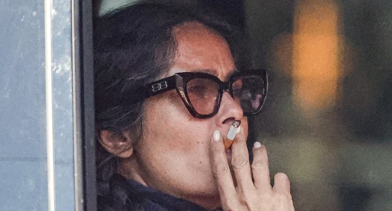 Salma Hayek puffs on a cigarette while stuck in traffic