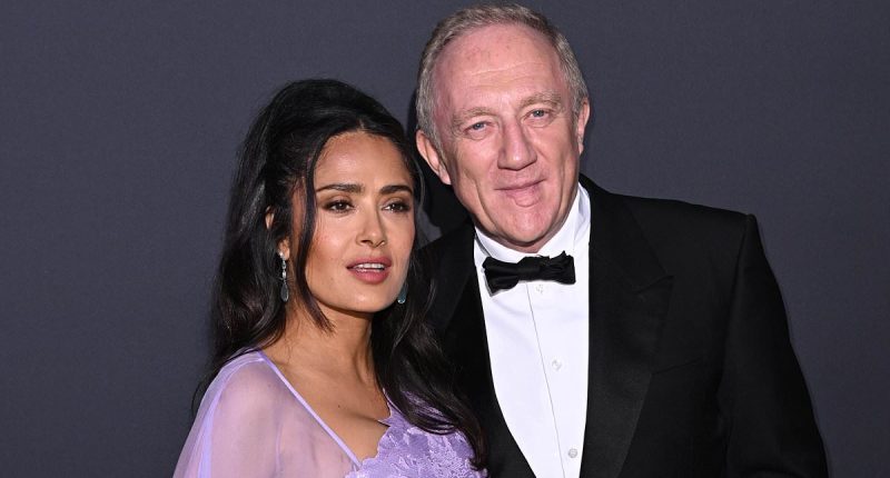 Salma Hayek wows in a caped lilac gown as she cosies up to husband