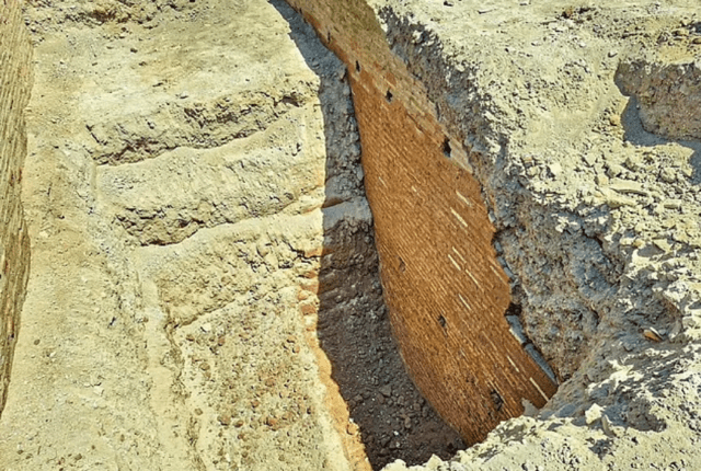 Excavated remains of an ancient brick wall.