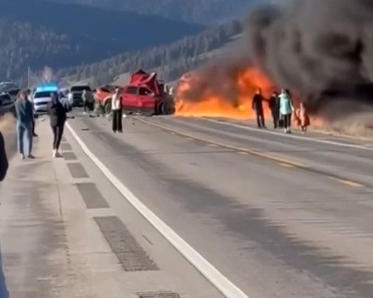 An image collage containing 1 images, Image 1 shows Burning vehicle on a highway with people watching