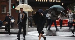 People are seen braving the rain on Friday, 23 May, 2025. The coastal trough responsible for bringing record rain to northern NSW has become more mobile after it was parked for days over soaked catchments. Picture - Sam Mooy / The Sydney Morning Herald