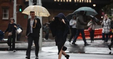 People are seen braving the rain on Friday, 23 May, 2025. The coastal trough responsible for bringing record rain to northern NSW has become more mobile after it was parked for days over soaked catchments. Picture - Sam Mooy / The Sydney Morning Herald
