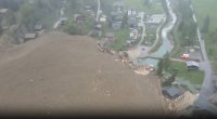 Aerial view of an avalanche destroying buildings in a village.