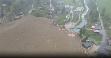 Aerial view of an avalanche destroying buildings in a village.