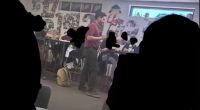 Teacher dressed as devil in classroom.