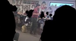 Teacher dressed as devil in classroom.