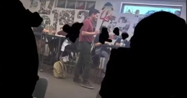 Teacher dressed as devil in classroom.