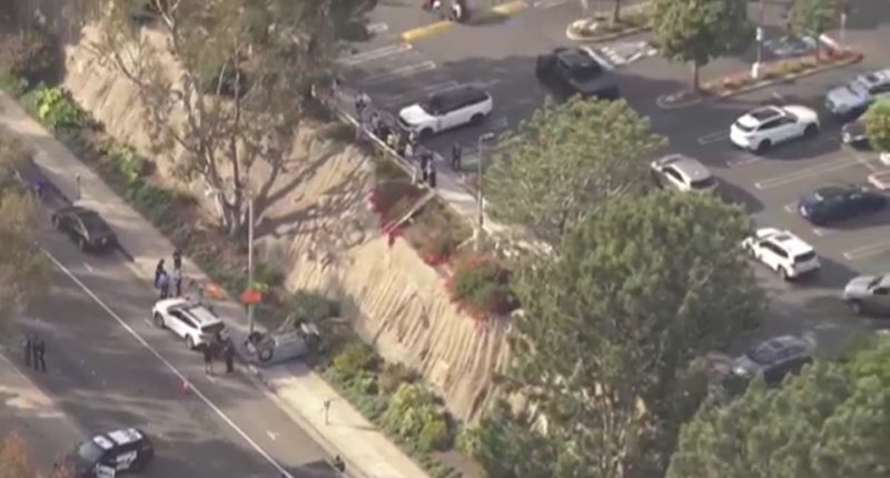 Aerial view of a car accident scene with emergency responders.